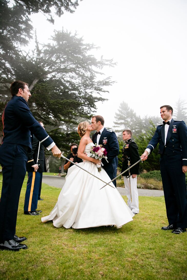 Jeff and Kim kissed between two swords drawn by Jeff's military friends in uniform.