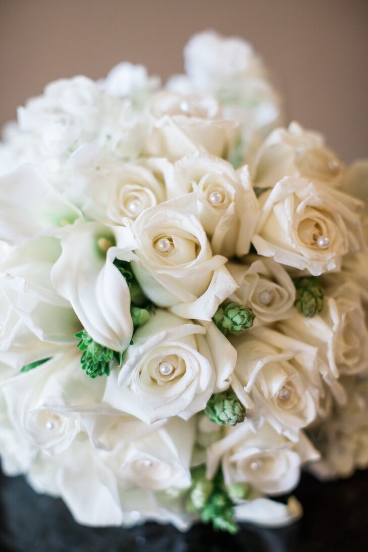 Kathy and Jon instituted a black tie theme as they had a limited guests list and wanted it to be a formal event. The bride had roses for her bouquet which were also used in the boutonnieres. The reception centerpieces were baby breaths in long white glass vases.