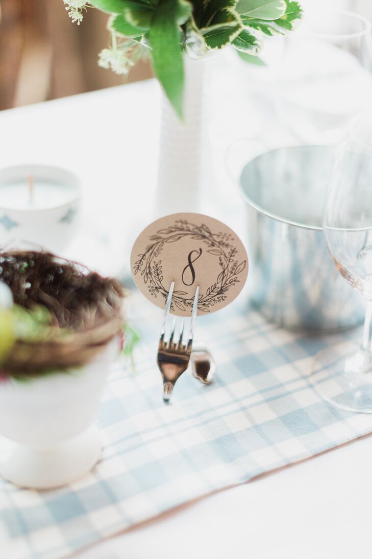 Twisted vintage forks held each table number, a black calligraphy numeral surrounded by a laurel. Love how this ties back to the homey cafe style too.