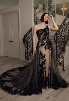 Woman in Amare Couture gown posing in front of staircase