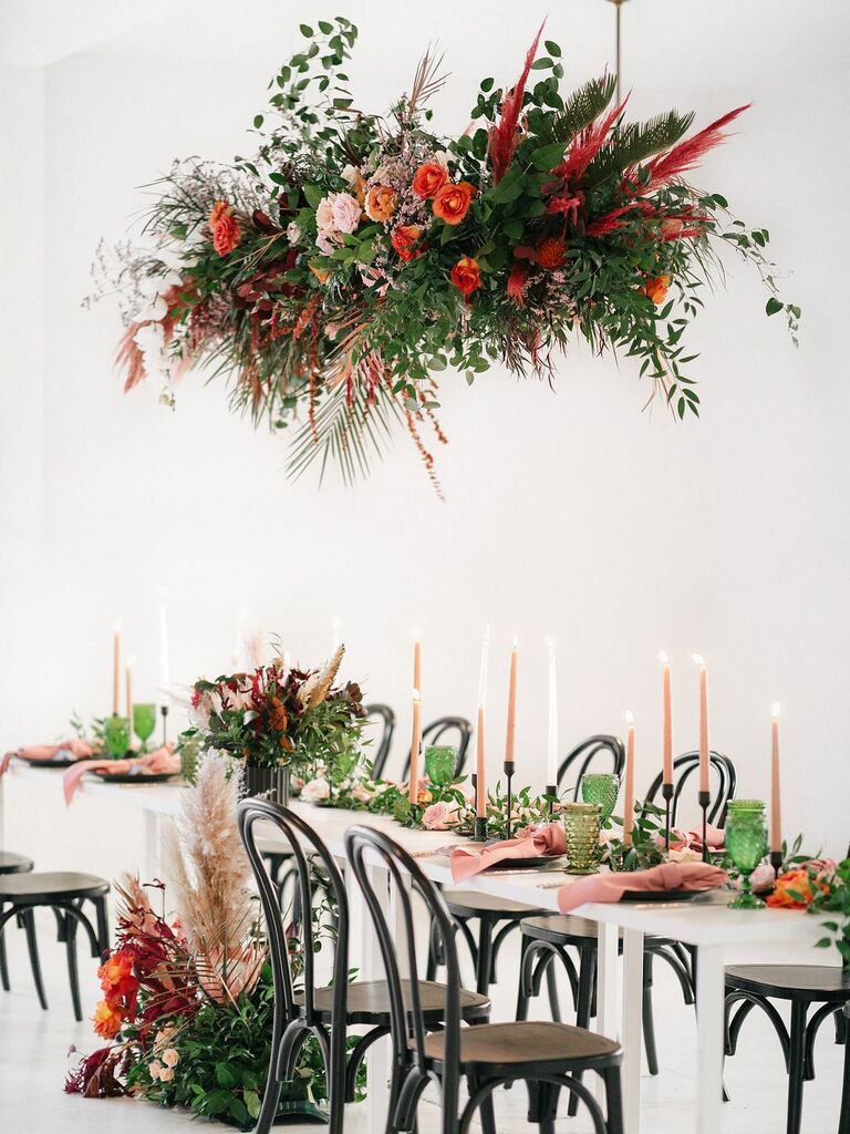 modern hanging flowers wedding centerpiece with red, orange and pink flowers and greenery