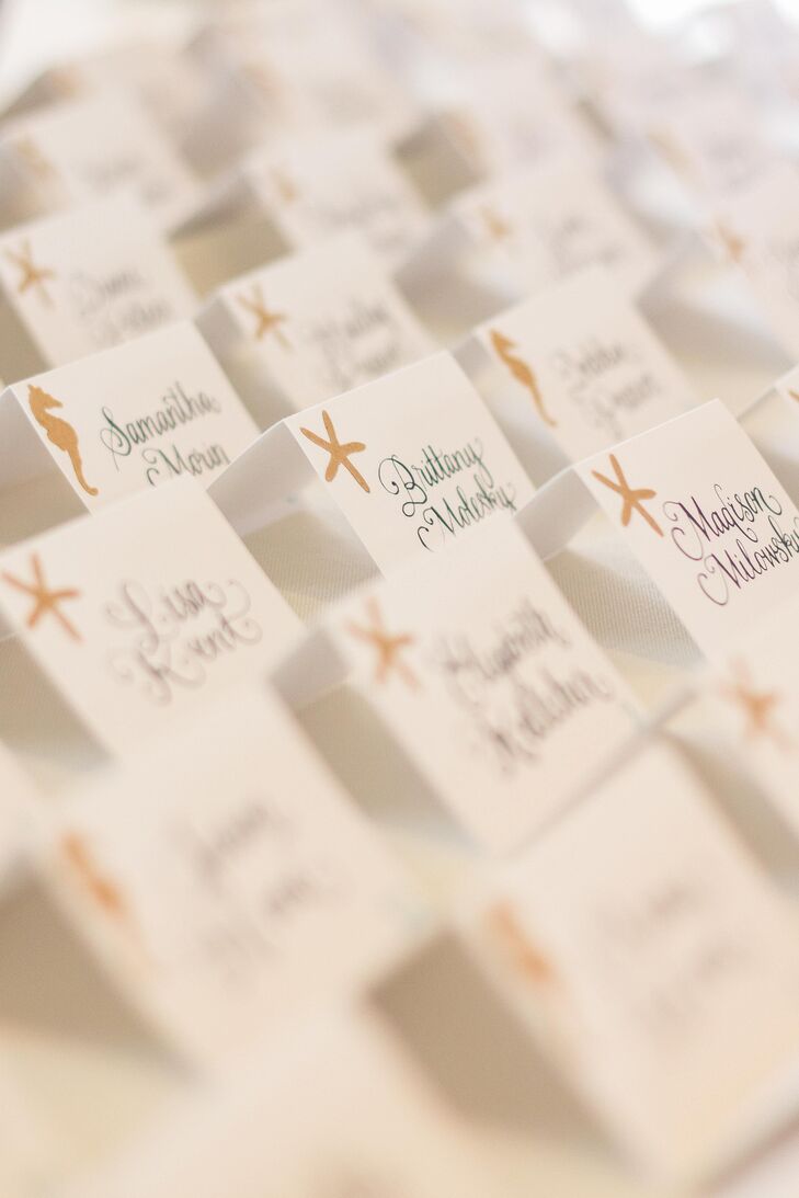 Tying into the wedding's nautical, beach theme, Alexandria and Brennan added a starfish and seahorse motif to the escort cards.