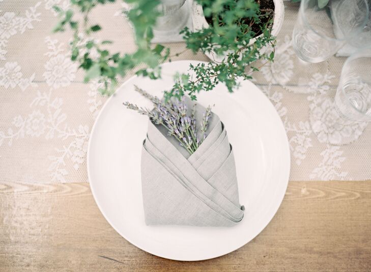 The organic table settings were kept clean with white plates, simple napkins and a sprig of lavender.