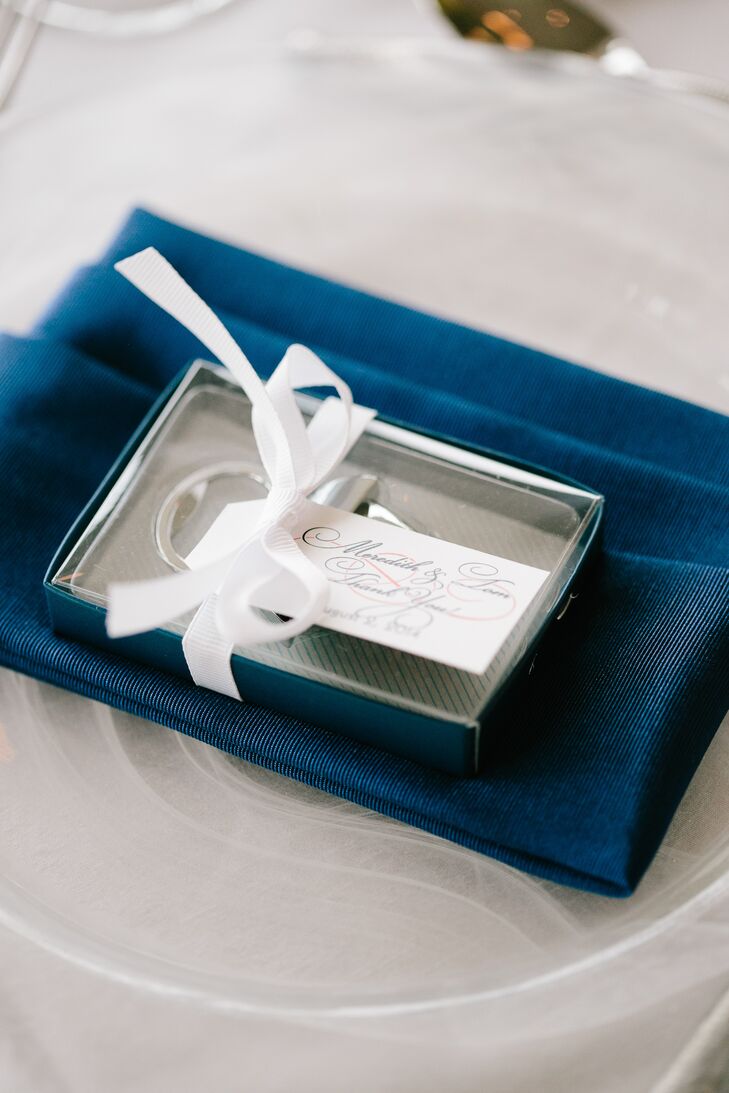 Elegant hand-calligraphed place cards were attached to customized bottle-opener favors at each setting.