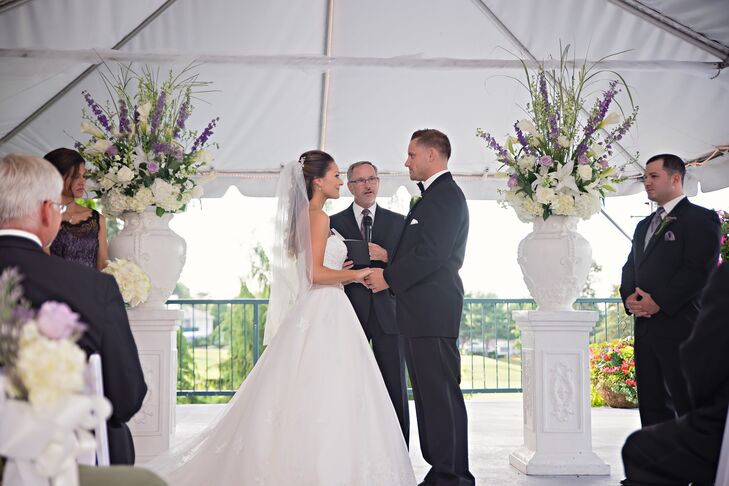 Mariel and Jeff exchanged vows at Kirkbrae Country Club in Lincoln, Rhode Island. “We found it online and fell in love with the beautiful grounds,” Mariel says. Wanting to complement the stunning venue, the couple brought the outside in with lush purple and ivory floral arrangements framing the altar.