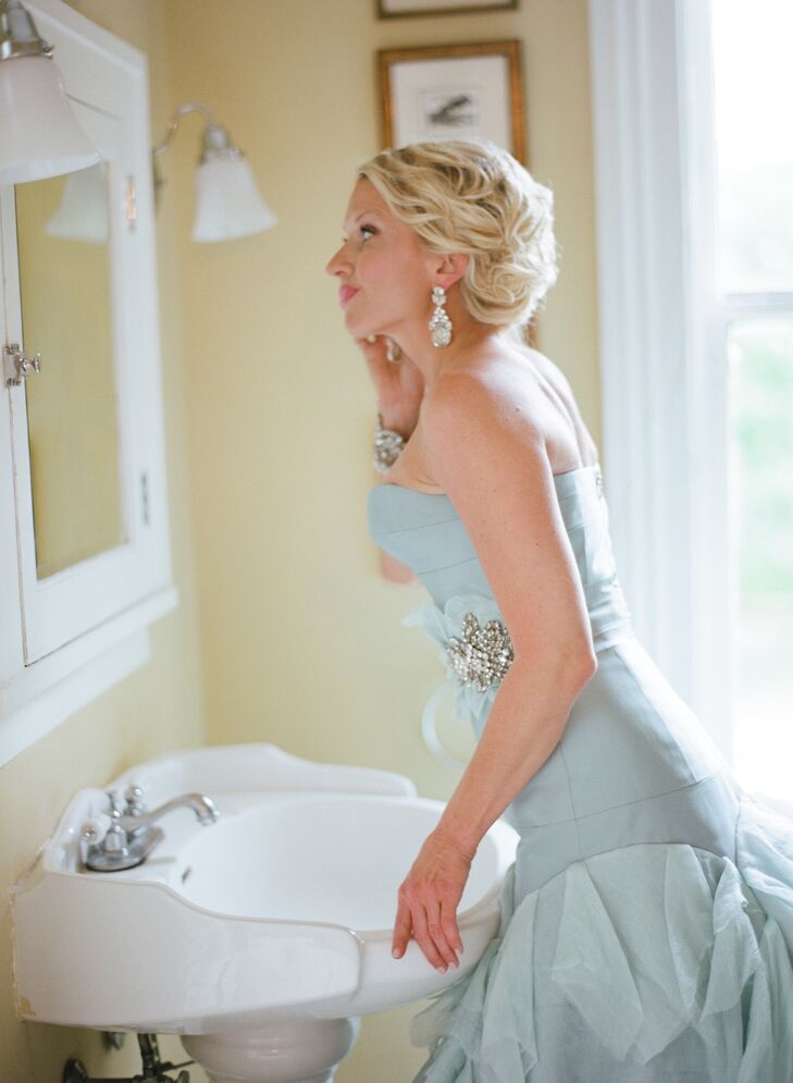 Jennifer, in a unique blue wedding gown, added the final touches before meeting Piran before the ceremony.