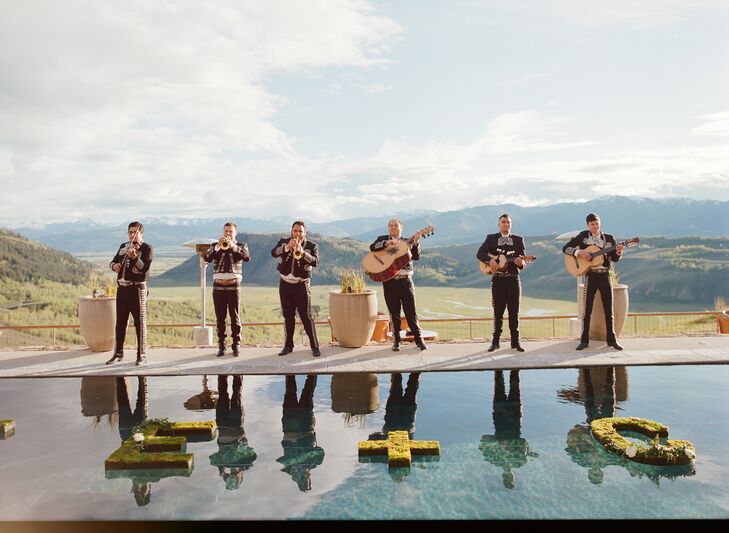 After the ceremony, guests were invited down the two cascading staircases to the pool. Situated facing the dramatic Wyoming mountains, the pool was the perfect location to place floating letters spelling “Katie + Cody.”