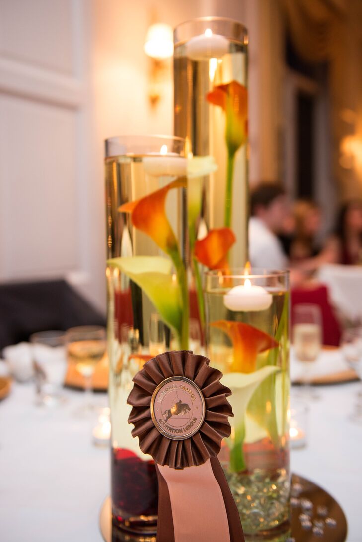 Centerpieces at the reception consisted of cylinder glass vases of varying heights filled with calla lilies and floating candles.