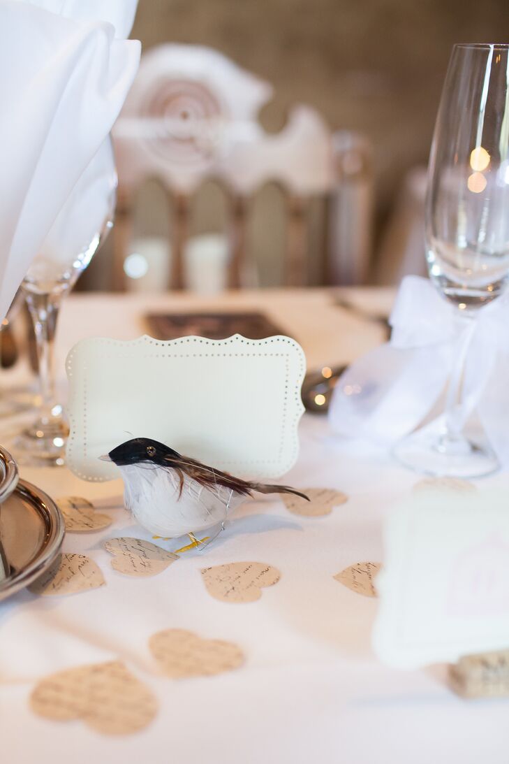 The table numbers were tucked next to artificial sparrows. Light brown paper hearts scattered across the tabletop completed the whimsical centerpiece decor.