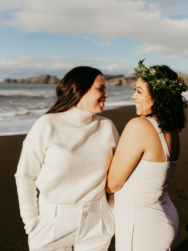 how to choose a wedding photographer couple smiling at each other on beach