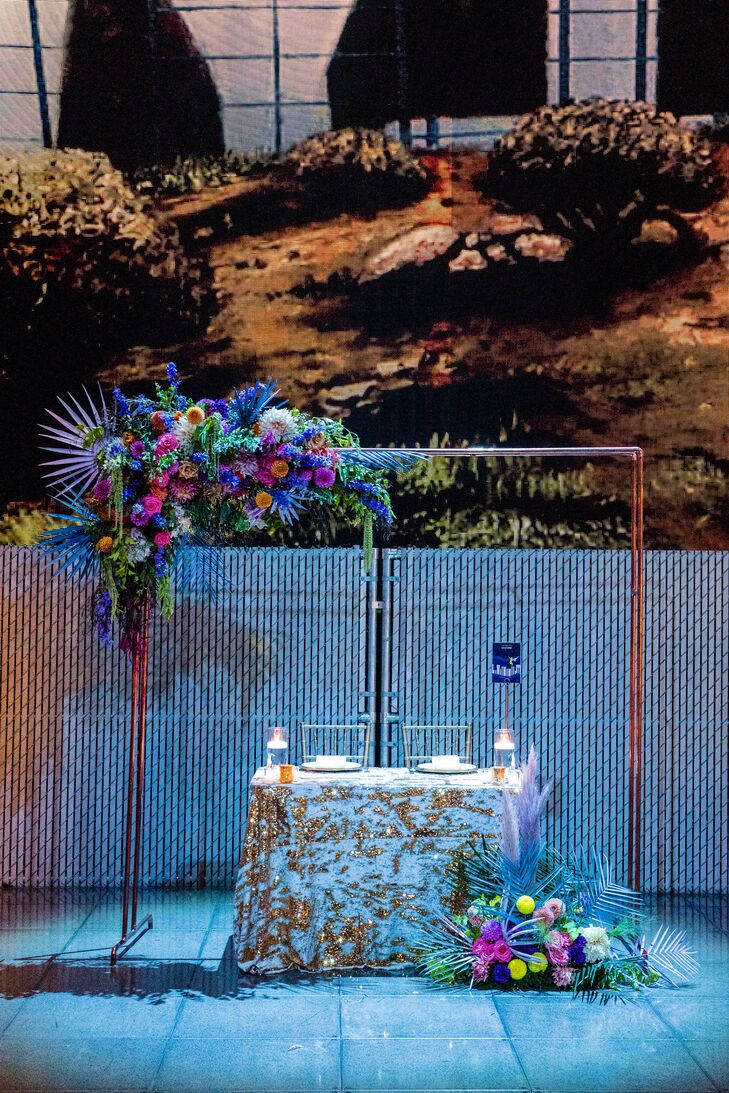 Colorful Flowers and Sweetheart Table Under Repurposed Wedding Arch