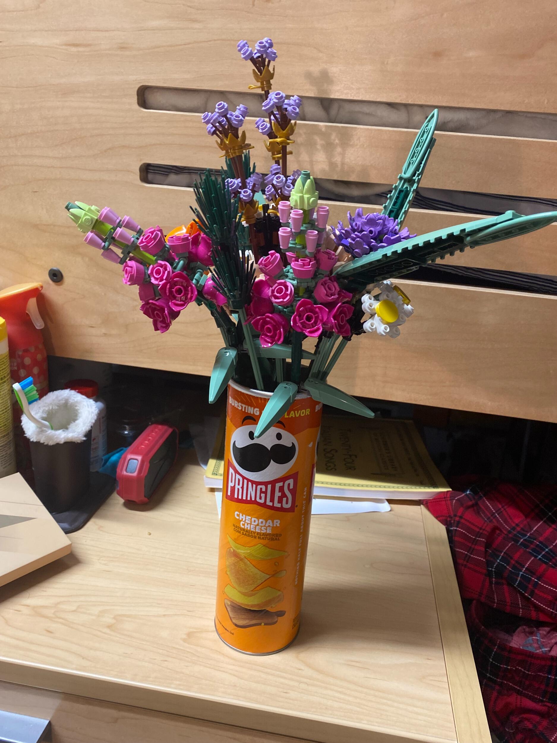 Their first Valentines Day together! The two spent the evening building a Lego bouquet together, however, they didn't have a vase. Using what they had, it was placed into a Pringles can where the bouquet still is today! 
