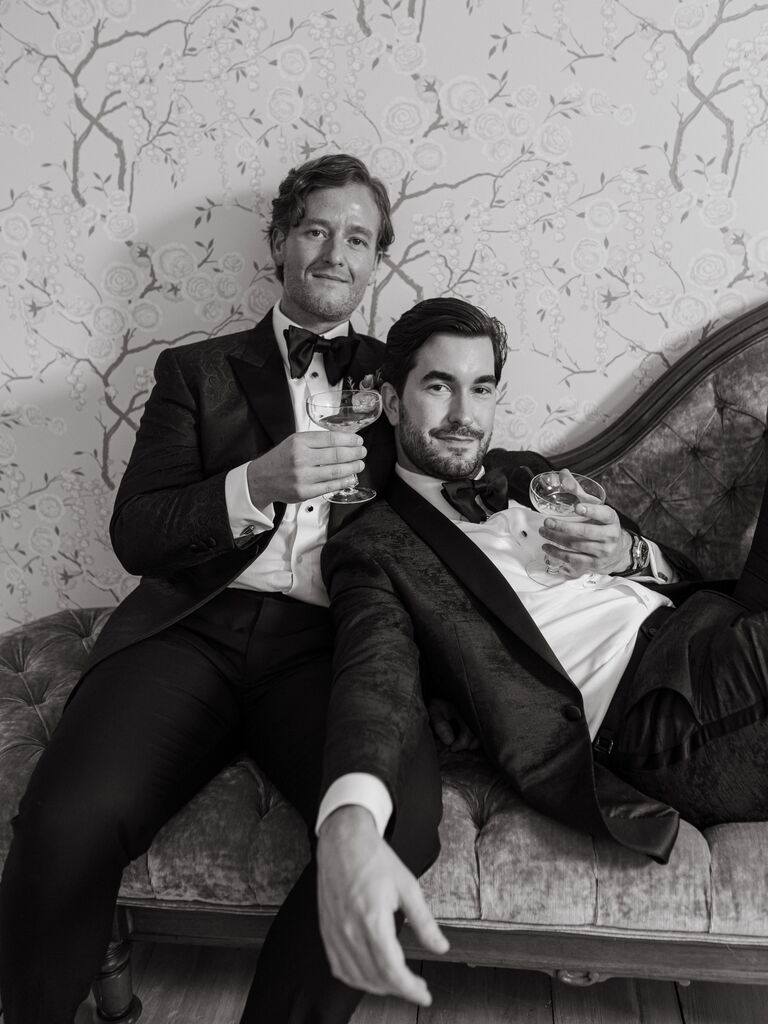 Michael Mendieta and Witaker Irvin holding champagne on their wedding day