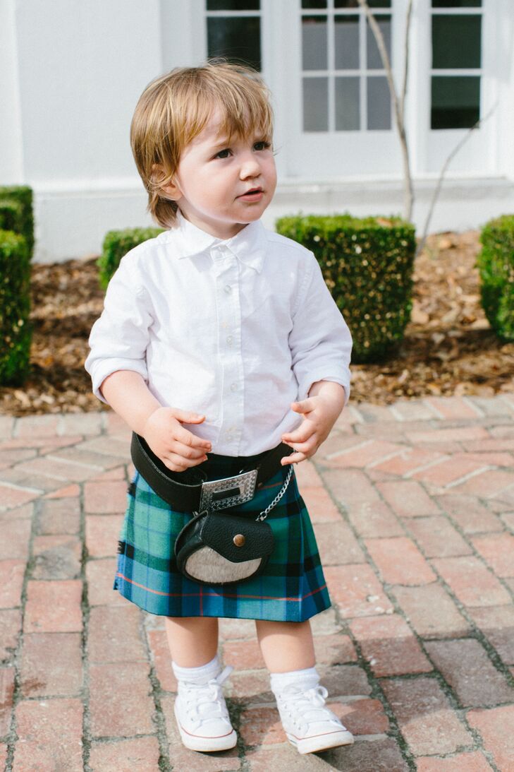Nina and Tristan's ring bearer wore a kilt in the Flower of Scotland tartan to match the groomsmen. He completed his look with a mini boutonniere and rocked some Converse sneakers as well.