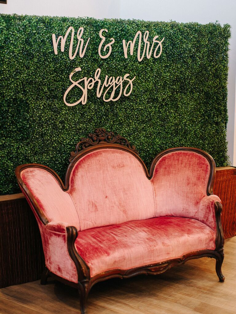 Boxwood wall with velvet sofa for photo booth