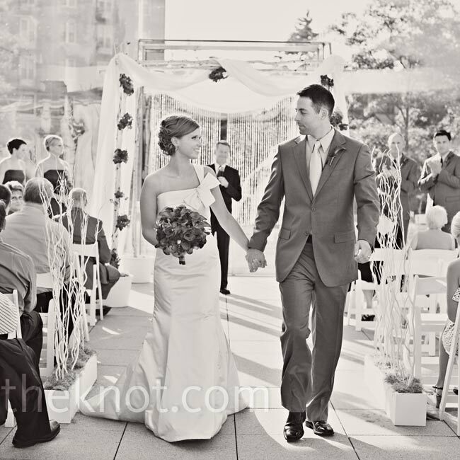 Tall branches lined the aisle and led up to the wall of windows that served as the ceremony backdrop.