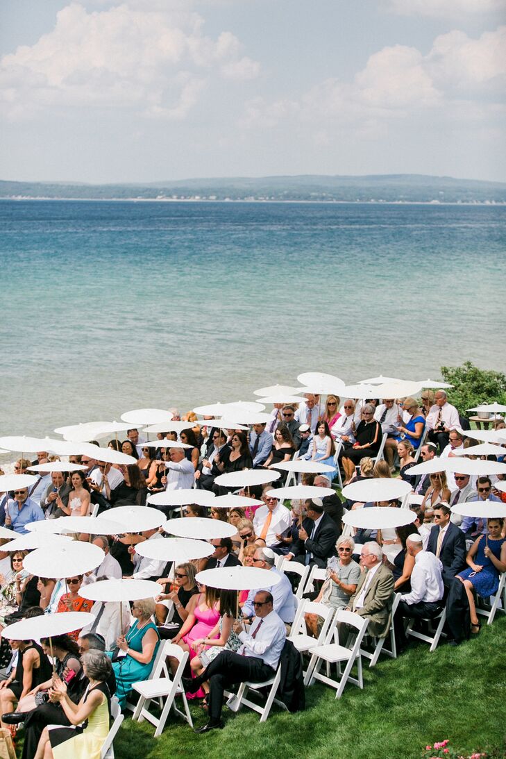Guests Under Umbrellas at Lakefront Northern Michigan Wedding