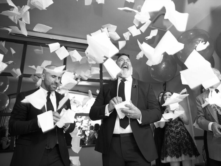 Guests throw napkins as the wedding exit toss. 