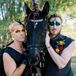 Grooms With Colorful Makeup Posing With Black Horse