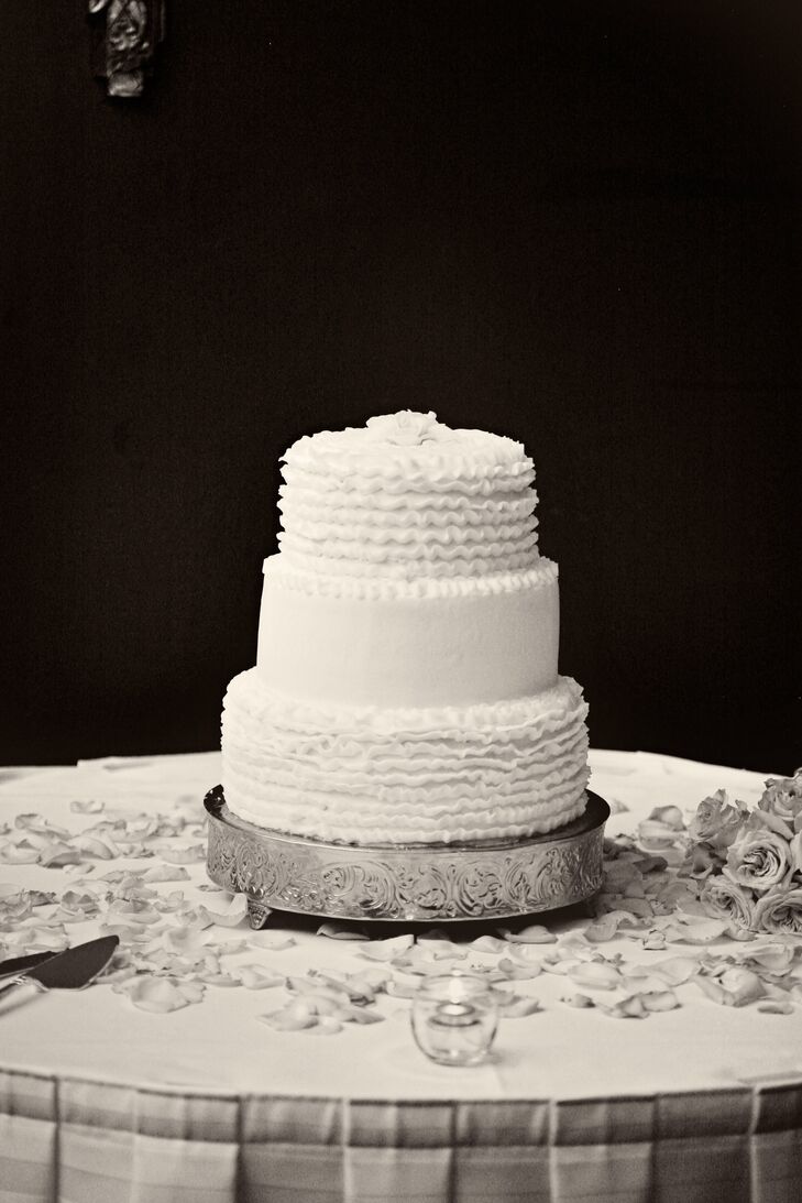 The three-tiered white cake was decorated with delicate ruffles.
