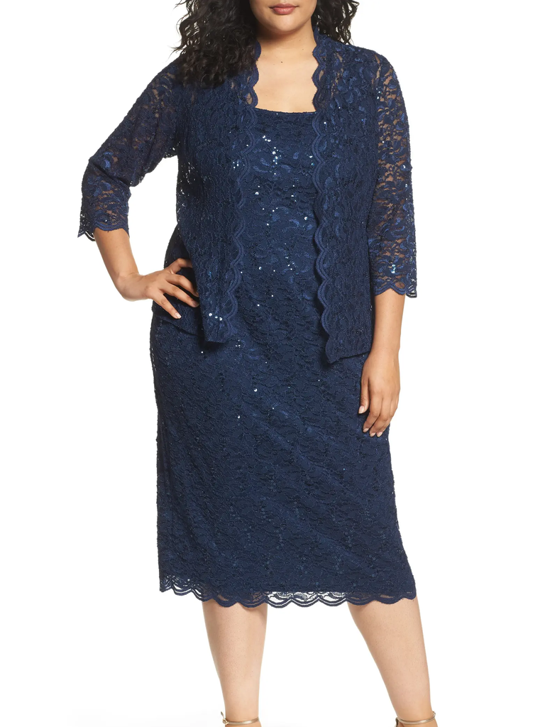 A model wears this two-piece navy dress with lace accents.