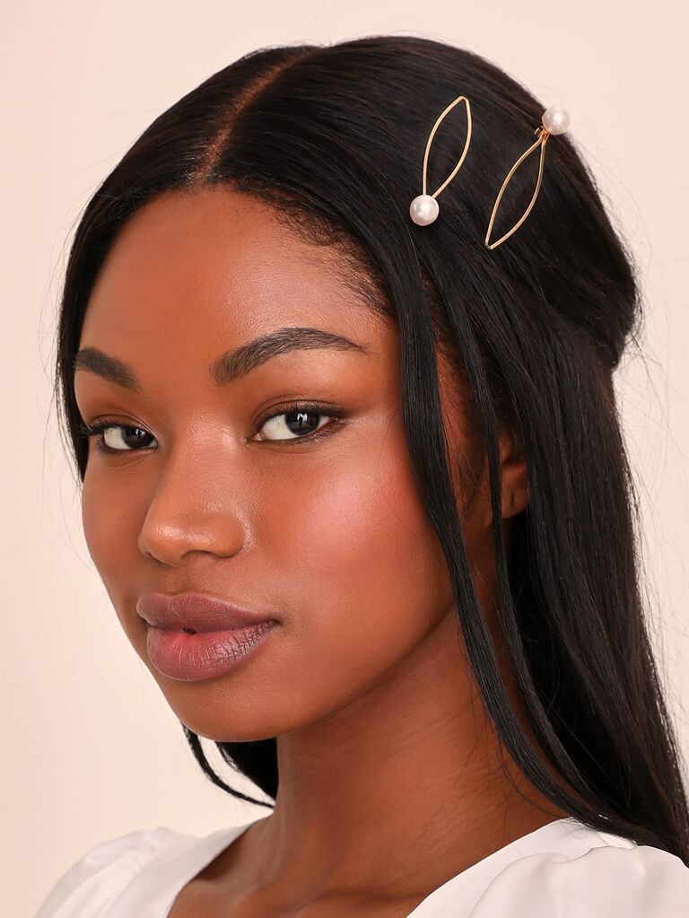 Model wears pearl hair pins in her hair. 