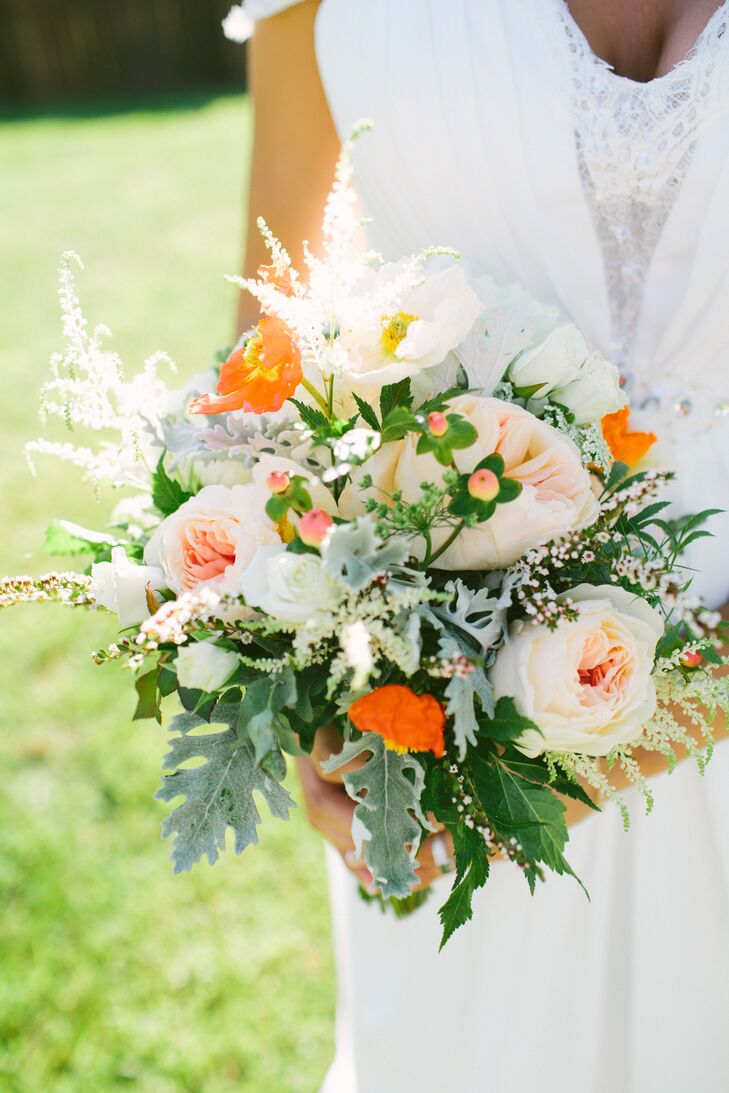 Lauren's bouquet was filled with blooms straight from her mother's garden. A fresh mix of blush garden roses, bright orange poppies, white anemones and an assortment of wispy greenery came together to create a whimsical look with a note of playfulness.