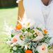 Lauren's bouquet was filled with blooms straight from her mother's garden. A fresh mix of blush garden roses, bright orange poppies, white anemones and an assortment of wispy greenery came together to create a whimsical look with a note of playfulness.