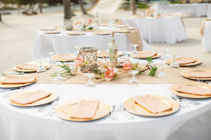 “For our centerpieces, we wanted something unique and natural that played off our surroundings,” says Whitney. Together, she and Ryan crafted decorated sand-blasted manzanita branches with silk flowers in shades of vibrant color to use as the focal point of the centerpieces. They then added starfish, seashells, wicker lanterns and gold votives to really play up the display’s beachy vibe. “My mom also antiqued blue bottles, which turned out to be amazing!” says Whitney.rn