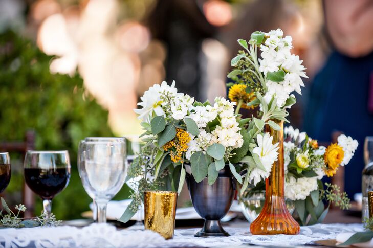 The bride and groom went for a rustic-meets-modern vibe, with raw wooden tables and platters, old lace runners, bronze candlesticks and mercury glass lanterns.