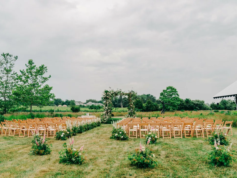 An outdoor ceremony site complete with natural-looking floral arrangements. 