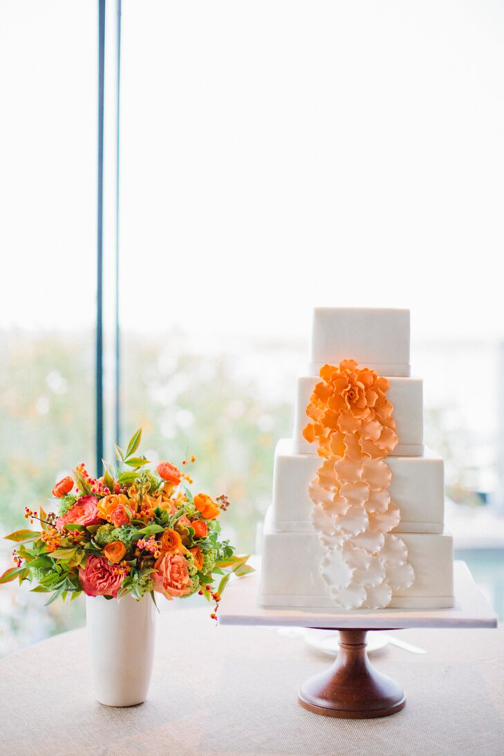 The couple’s four-tier square cake was embellished with sugar flowers cascading down the side.