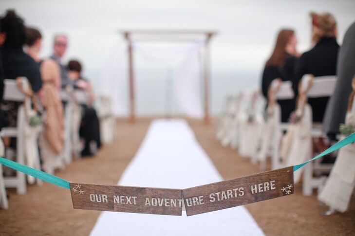 At the beginning of the crisp, white aisle -- a stark contrast to the bohemian beach setting -- was a wooden sign.