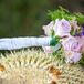 Stephanie carried a purple bouquet with long stems wrapped in white fabric.