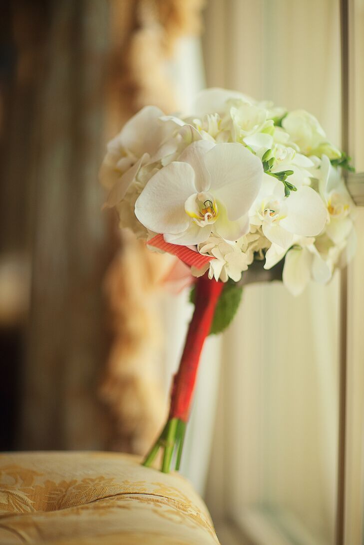 Amina accented her unique red organza Vera Wang ball gown with a bouquet of white orchids and hydrangea arranged by Tiger Lily Flowers.