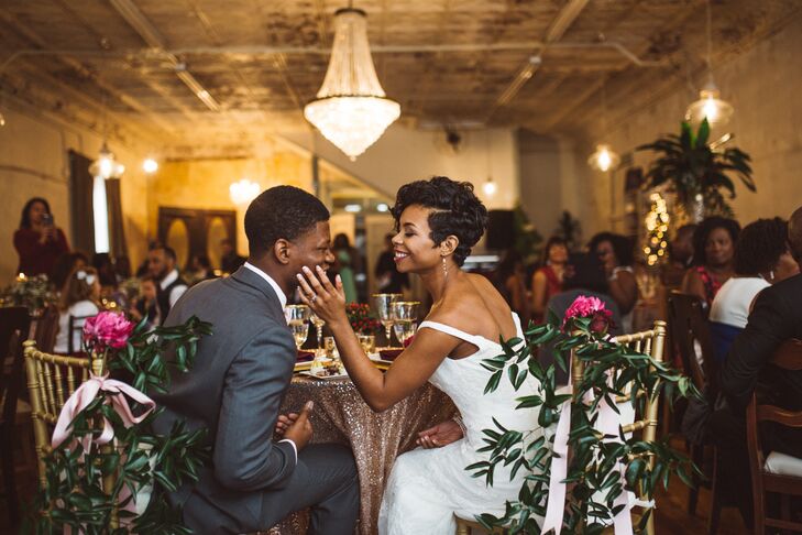 Instead of having a head table, Morgan and Stanley opted for an intimate sweetheart table for the reception, which offered them the opportunity to share a few private moments throughout the evening. The table was draped in a rose gold sequin cloth that exuded glitz and glamour, while gilded chiavari chairs were adorned with ranunculus and Southern smilax swags to create a whimsical, romantic effect.