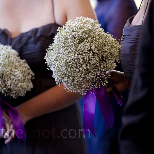 The bridesmaids carried big bouquets of baby’s breath wrapped in purple ribbon.