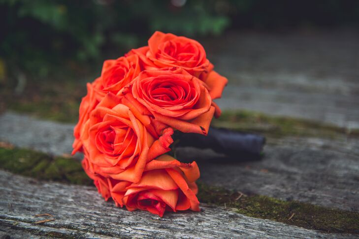 Each bridesmaid carried an orange bouquet of different flowers.