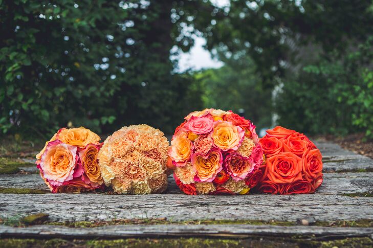 The bridal party carried bright orange bouquets, adding a burst of color to their bridal style.