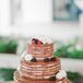 Dessert is Trey’s favorite part of every meal, and it was important to him that the cake looked as good as it tasted! A naked cake was the way to go for their rustic, natural wedding: It was a three-tiered carrot cake with vanilla cream cheese frosting and drizzled caramel sauce with fresh flowers and berries on top. Also, their cake was totally gluten-free!