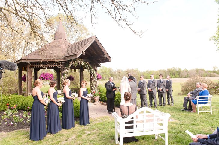The bridesmaids wore these long navy dresses with a one-shoulder strap and empire waist. To change things up, each woman chose a different updo hairstyle. “Everyone looked stunning,” Rachael says.