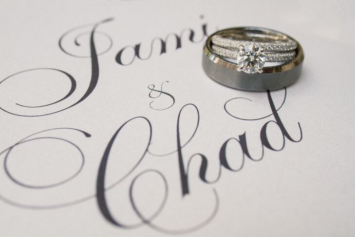 After three years of dating Jami, Chad proposed during a sweet evening at home. “We are both pretty introverted, so a flashy proposal wouldn't have suited either of our styles,” Jami says. He gave her a classic round diamond solitaire with matching diamonds all over the ring. Her wedding ring matched it perfectly. As for Chad, he wanted something a little more understated and went with a sleek titanium ring.