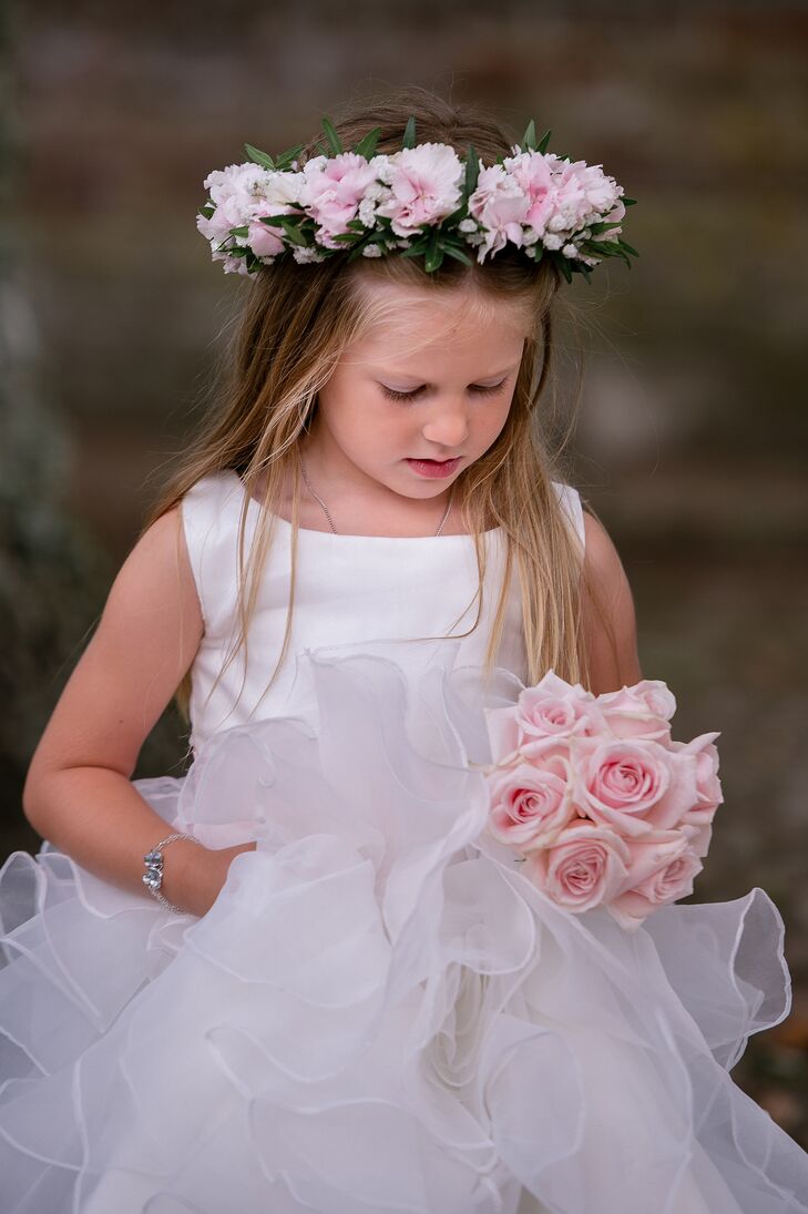 The couple's daughter wore a custom-made dress with a ruffled tulle skirt and a crown of blush flowers. She also carried a blush rose bouquet to match her mother's.