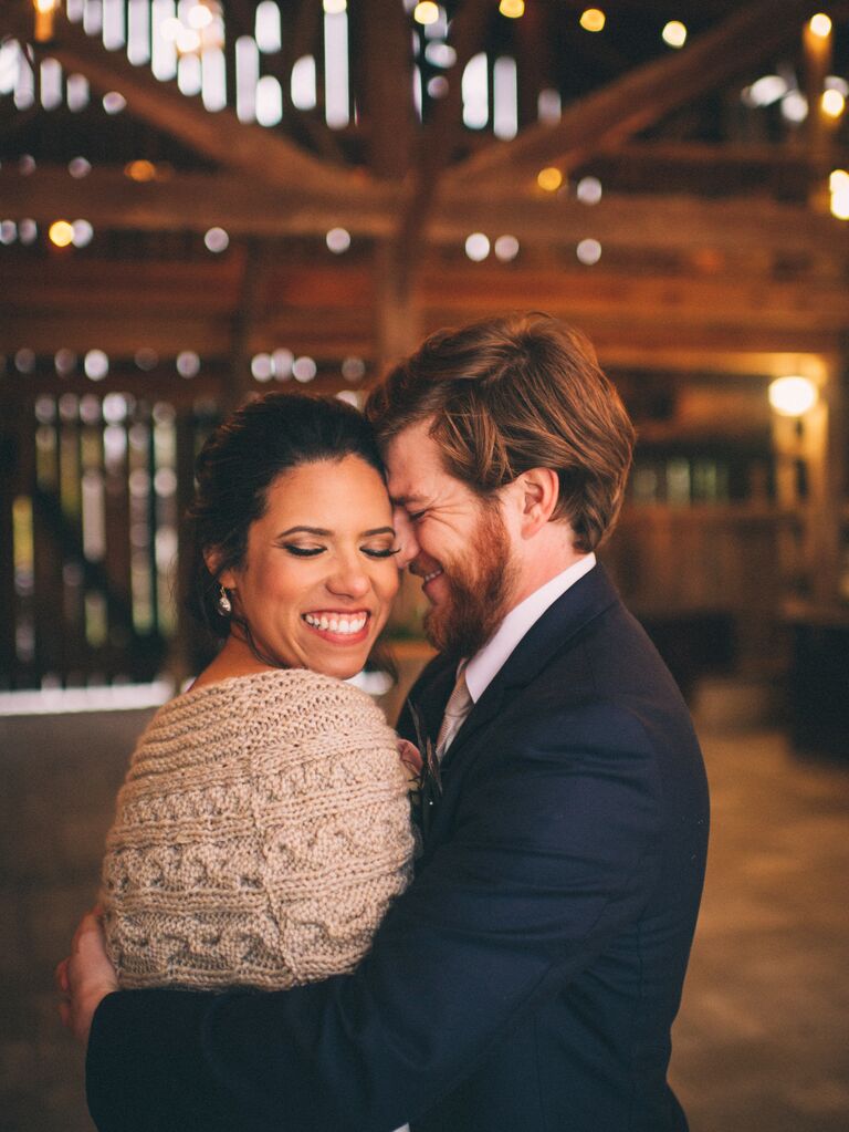 A man and woman share an intimate moment in the evening for their fall engagement photoshoot