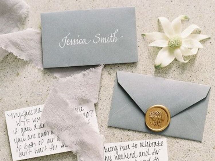 An invitation styled with flannel flower blooms
