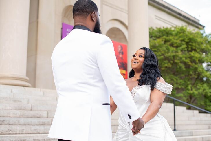 Groom in White Tuxedo Jacket Holding Hands With Bride in Off-the-Shoulder Gown, First Look