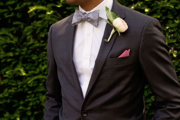 Them men accessorized their dark gray suits with gingham bow ties and cranberry pocket squares to match the bridesmaid dresses.