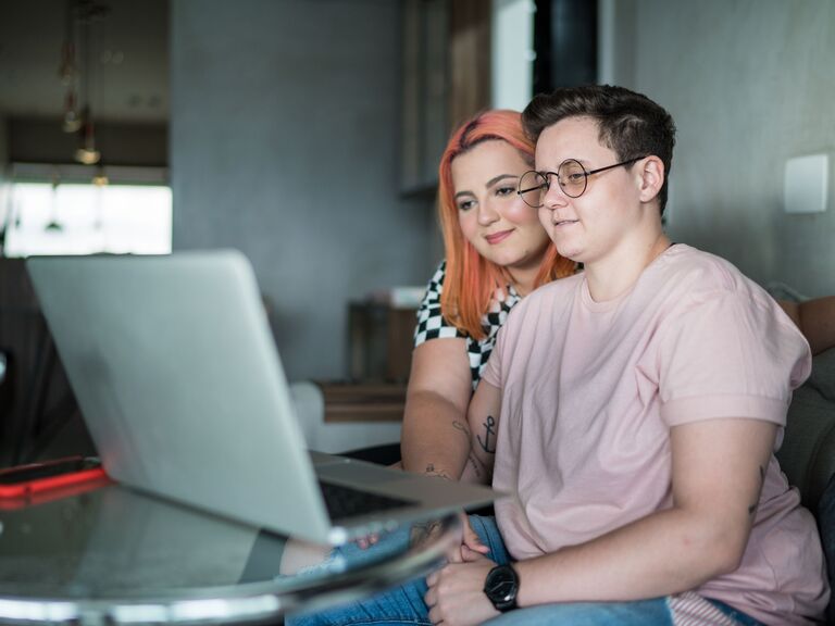 Couple doing online couples counseling on laptop together