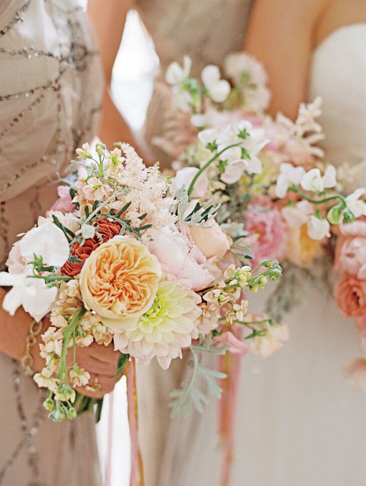 A mix of pink garden roses, peonies, sweet peas, dahlias, stock and zinnias made up the bridesmaid bouquets.