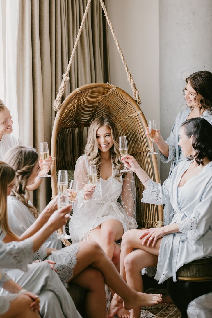 Getting-Ready Champagne Toast with Bride and Bridesmaids Wearing Robes